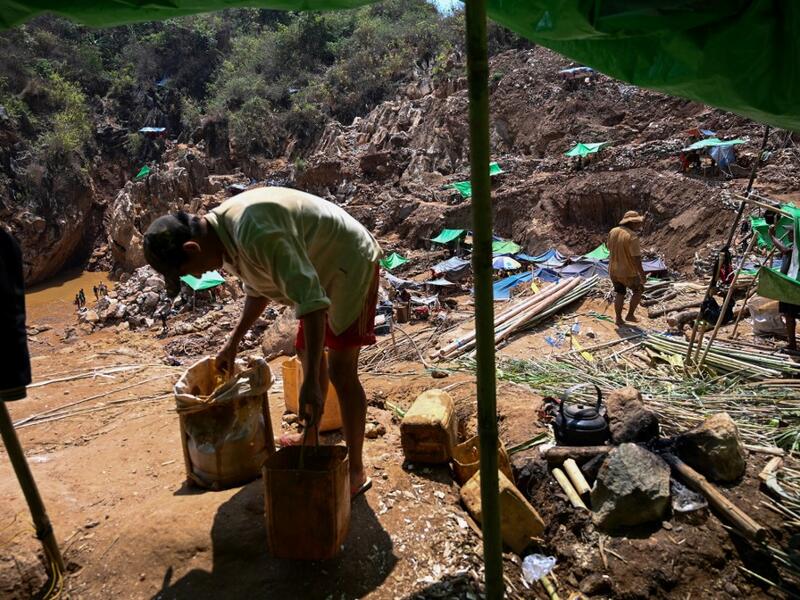 This photo taken on May 16, 2019 shows miners collecting earth containing rubies and other gemstones in a ruby mine in Mogok, north of Mandalay. Burrowing deep underground, thousands of informal miners risk their lives to find gleaming red gems as a law change spurs opportunity in Myanmar's "land of rubies". Ye Aung THU / AFP