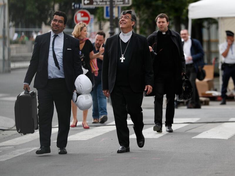 Archbishop of Paris Michel Aupetit (C) arrives to hold the first mass of the Notre-Dame de Paris cathedral two months after the fire, on June 15, 2019 in Paris. The Notre-Dame cathedral in Paris will host its first mass on June 15, 2019. Zakaria ABDELKAFI / AFP