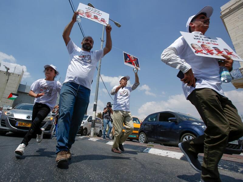 Palestinians hold protest signs showing the crossed-out faces of (L to R) Israeli Prime Minister Benjamin Netanyahu, US President Donald Trump, King Hamad al-Khalifa of Bahrain, and Saudi Crown Prince Mohammed bin Salman. Musa Al SHAER / AFP