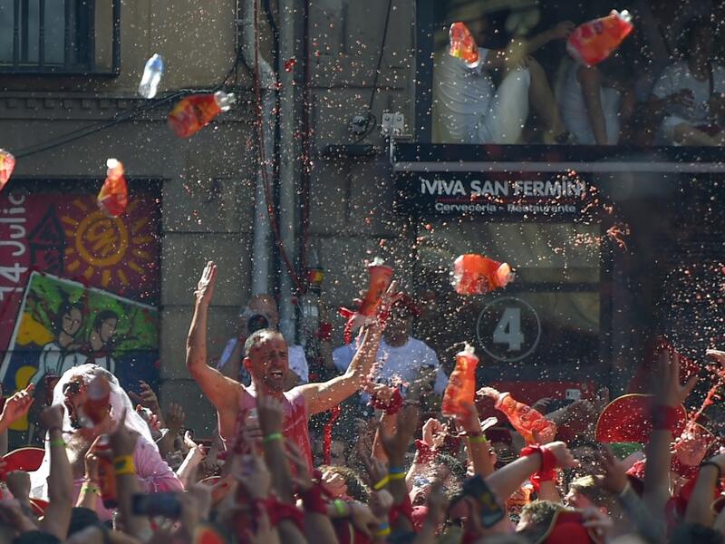 Revellers celebrate during the 'Chupinazo' (start rocket) to mark the kickoff at noon sharp of the San Fermin Festival, in front of the Town Hall of Pamplona, northern Spain, on July 6, 2019.  ANDER GILLENEA / AFP