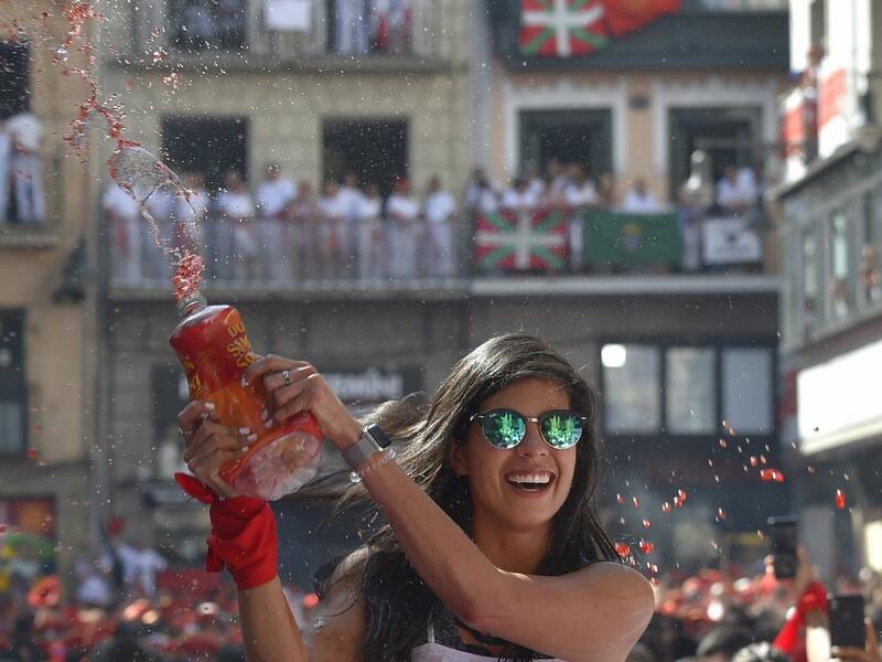 A reveller celebrates during the 'Chupinazo' (start rocket) to mark the kickoff at noon sharp of the San Fermin Festival, in front of the Town Hall of Pamplona, northern Spain, on July 6, 2019.  ANDER GILLENEA / AFP