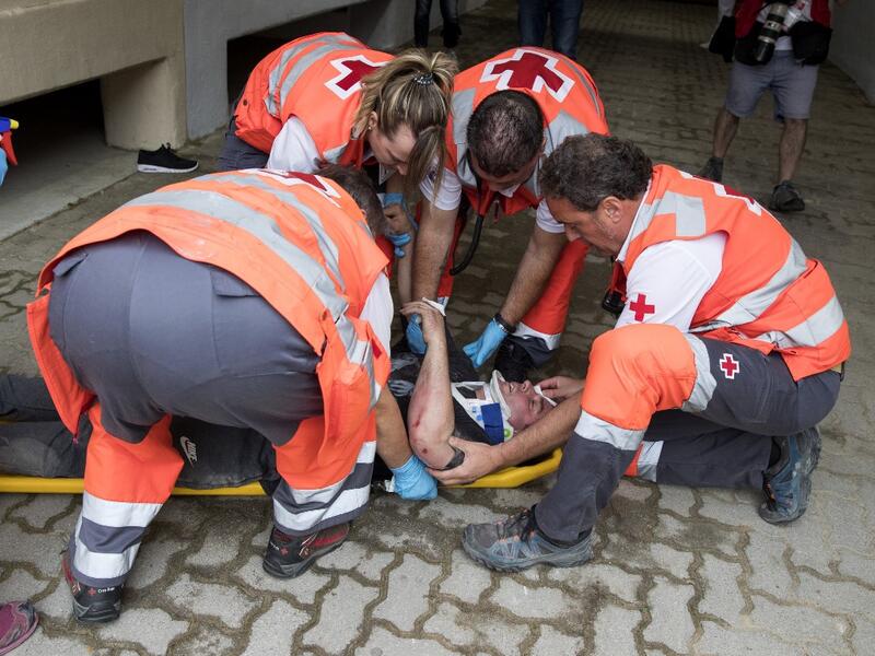 A participant receives medical assistance during the first bull-run of the San Fermin festival in Pamplona, northern Spain on July 7, 2019. JAIME REINA / AFP