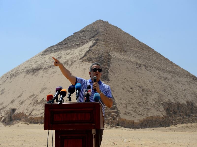 Egypt's Antiquities Minister Khaled El-Enany speaks in front of the Bent Pyramid of Sneferu during an inaugural ceremony of the pyramid and its satellites, on July 13, 2019. Mohamed el-Shahed / AFP