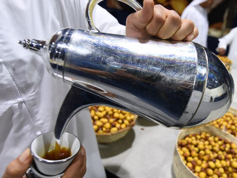An Emirati man pours coffee during the annual Liwa Date Festival in the western region of Liwa on July 17, 2019. Karim SAHIB / AFP
