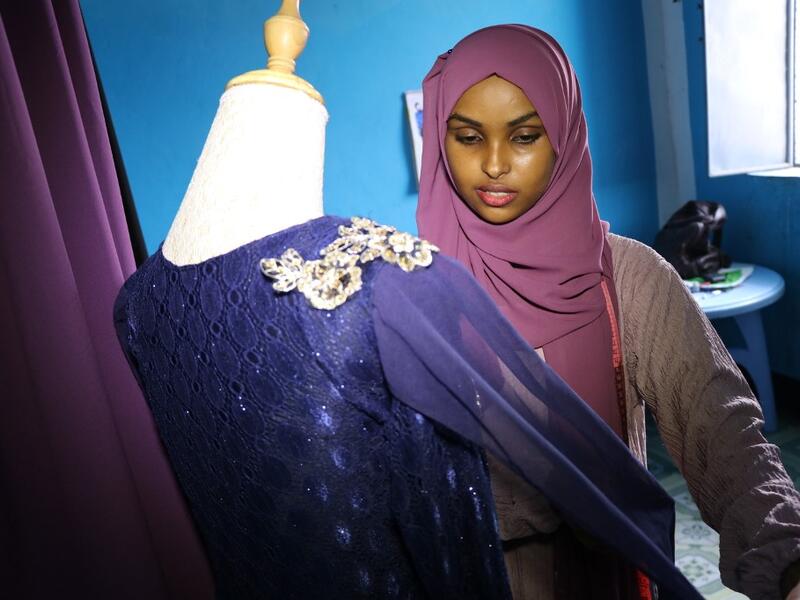 Hawa Adan Hassan, a 23 year-old university student and a young Somali female fashion designer checks her new finished fashion design, on November 3, 2018, in Mogadishu. Abdi HAJJI HUSSEIN / AFP