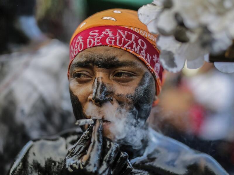 A catholic faithful smeared in burnt oil, takes part in the opening of the ten-day celebration of the Santo Domingo de Guzman festival in Managua, on August 1, 2019.  INTI OCON / AFP