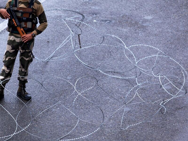 A security personnel stands guard at a roadblock in Jammu on August 7, 2019. A protester died after being chased by police during a curfew in Kashmir's main city, left in turmoil by an Indian government move to tighten control over the restive region, a police official said on August 7. Rakesh BAKSHI / AFP