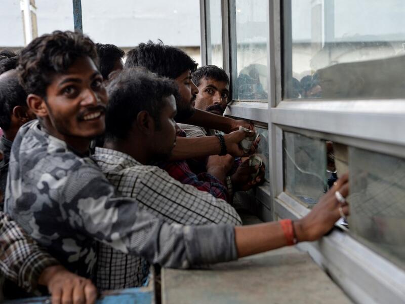 Labourers from across India working in Kashmir buy bus tickets at a counter of Jammu and Kashmir Tourist Reception Centre (JKTRC) to leave the city due to the heightened security situation in Srinagar  Sajjad HUSSAIN / AFP