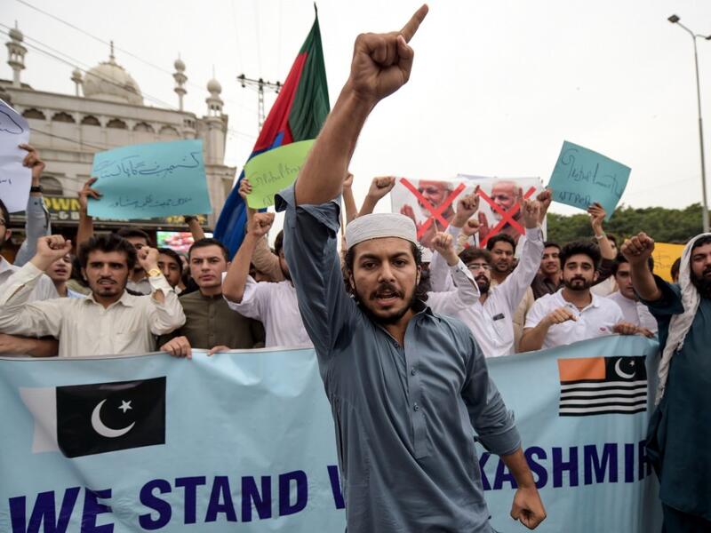 Students of Islami Jamiat-e-Talaba (IJT), a wing of religious political party Pakistan Jamaat-e-Islami (JI), burn a photograph of Indian Prime Minister Narendra Modi during a protest in Peshawar  ABDUL MAJEED / AFP