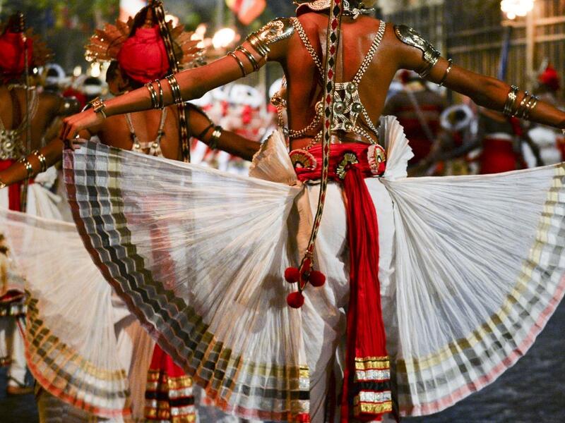 In this photograph taken on August 14, 2019 dancers perform during the "Esala Perahera" festival near the Buddhist temple of the Tooth in the ancient hill capital of Kandy, some 116 kilometres from Colombo. Lakruwan WANNIARACHCHI / AFP