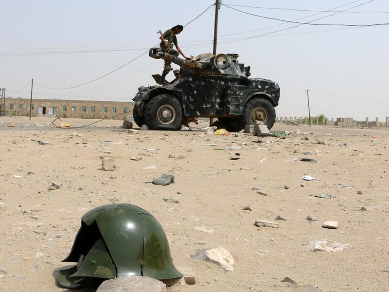 A Fighter stands atop a military vehicle in Yemen (AFP)
