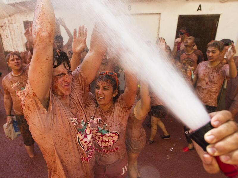 Afterwards, the streets are hosed down by organisers with people either hosing themselves, having a shower or diving into public lakes to get the pulp off. (AFP/ File Photo)
