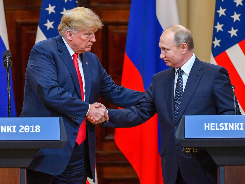 US President Donald Trump shakes hands with Russian President Vladimir Putin at the end of their summit in Helsinki, Finland, on Monday, July 16. (Yuri Kadobnov/AFP/Getty Images)