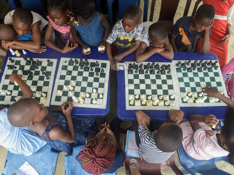 They are thinking about the next move they will make, as part of a project that is supposed to bring hope to a slum in Nigeria's megapolis. While dozens of matches are played simultaneously, participants, some as young as three years old, practice this brain game often considered out of reach for the poor populations of Africa's most populous country. PIUS UTOMI EKPEI / AFP