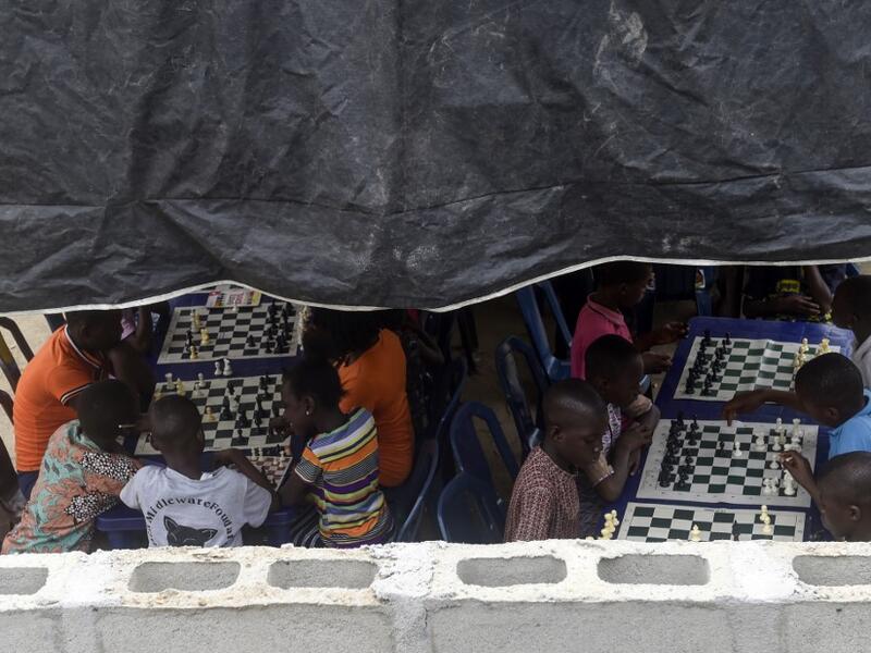 They are thinking about the next move they will make, as part of a project that is supposed to bring hope to a slum in Nigeria's megapolis.  PIUS UTOMI EKPEI / AFP