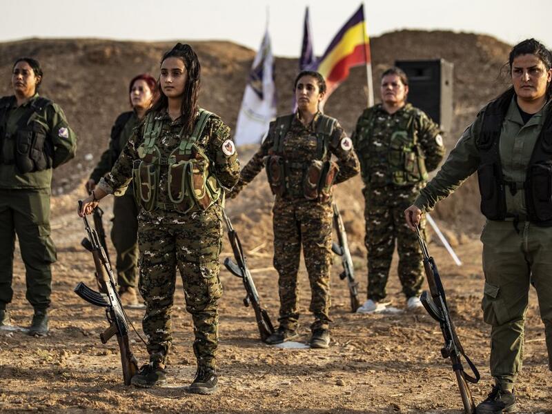 Members of the Bethnahrin Women Protection Forces (HSNB), an all-female Syriac-Assyrian paramilitary group under the umbrella of the Syrian Democratic Forces (SDF), line-up as they commemorate the fourth anniversary of their creation, in the countryside of the town of Tall Tamr in the northwestern Syrian province of Hasakah, on August 30, 2019.  Delil SOULEIMAN / AFP