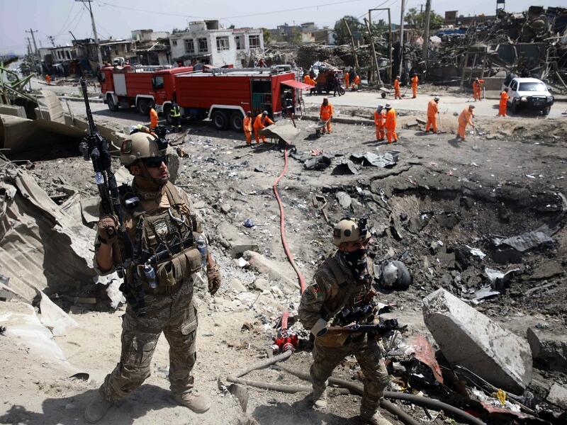 Afghan security forces walks as municipal workers gather to clean up near the crater from where a tractor packed with explosives exploded the night before at the Green Village in Kabul on September 3, 2019. (AFP/ File Photo)