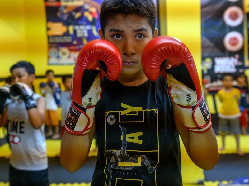 In this photograph taken on August 29, 2019, children from Muslim Uighur minority take part in a Muay Thai training session in Istanbul. BULENT KILIC / AFP