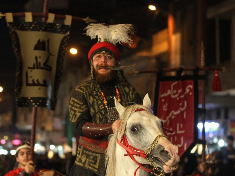 Iraqi Shiites in costumes re-enact events of Ashura in the capital Baghdad's mostly Shiite neighbourhood of Kadhimiya, marking the 8th day of Muharram.  Ahmad AL-RUBAYE / AFP