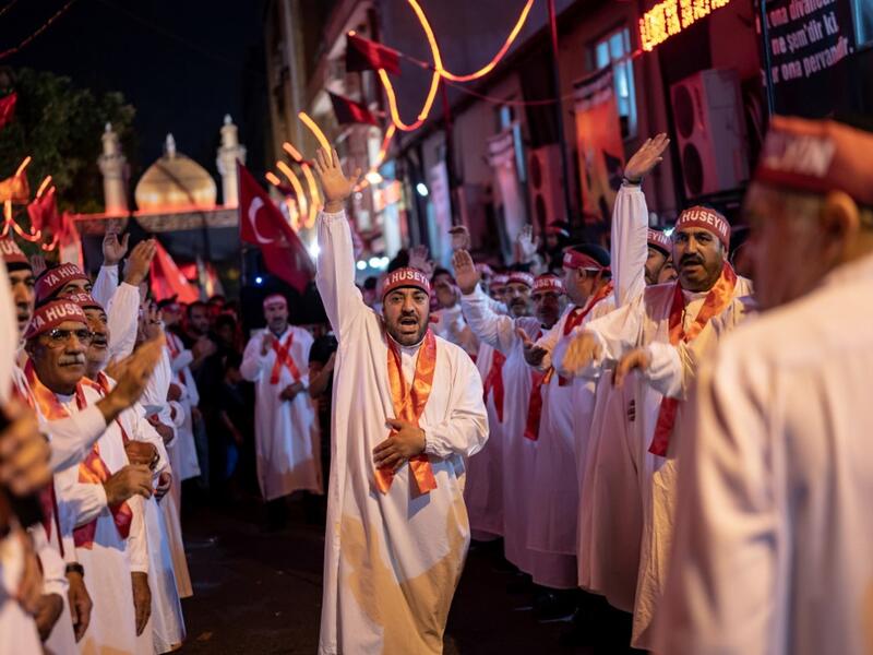 Turkish Shiite men walk during the Shi'ite Tasoua religious event, a day ahead of Ashura on September 8, 2019, in Istanbul. Ashura commemorates the killing of Imam Hussein, a grandson of the Prophet Mohammed, by armies of the caliph Yazid in 680 AD. Tradition holds that the revered imam was decapitated and his body mutilated in the Battle of Karbala. Yasin AKGUL / AFP