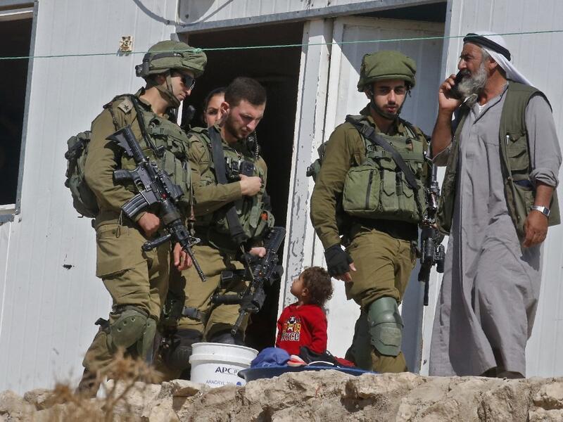 Israeli forces evict Palestinians from mobile homes built by EU funding and undergoing Israeli demolition in the village of Mufagara south of Yatta near Hebron in the occupied West Bank on September 11, 2019. (AFP/ File Photo)