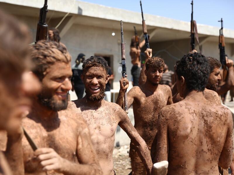 Syrian Turkish-backed fighters from al-Mutasim Brigade react after finishing their training at a camp near the town of Marea in Syria's northern Aleppo district, on September 12, 2019. Nazeer Al-khatib / AFP