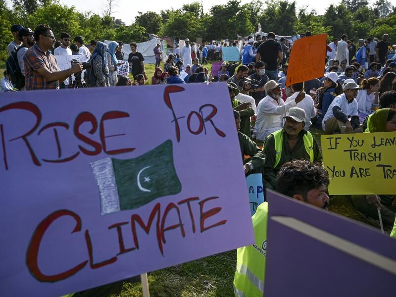 Youths hold placards as they sit during a climate strike to protest against governmental inaction towards climate breakdown and environmental pollution, part of demonstrations being held worldwide in a movement dubbed "Fridays for Future", in Islamabad on September 20, 2019. AAMIR QURESHI / AFP