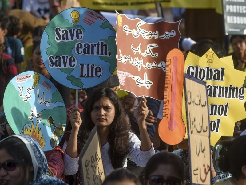 Youths hold placards as they march for a climate strike to protest against governmental inaction towards climate breakdown and environmental pollution, part of demonstrations being held worldwide in a movement dubbed "Fridays for Future", in Karachi on September 20, 2019. ASIF HASSAN / AFP