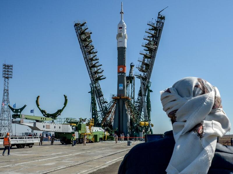 A United Arab Emirates' journalist looks on as the Soyuz booster rocket FG with Soyuz MS-15 spacecraft is mounted on the launch pad at the Russian-leased Baikonur cosmodrome in Kazakhstan on September 23, 2019. Vyacheslav OSELEDKO / AFP