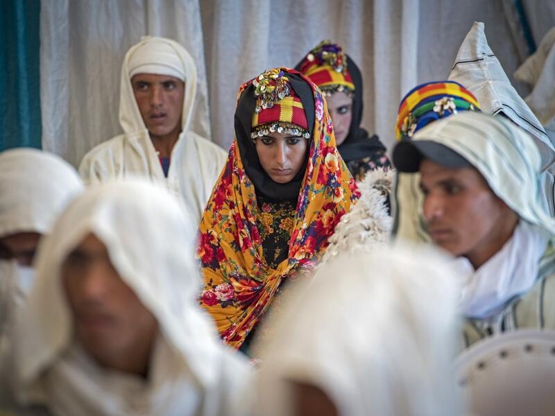 Young Amazigh (Berber) men and women wait for their wedding ceremony during the annual "Engagement Moussem" festival near the village of Imilchil in central Morocco's high Atlas Mountains on September 21, 2019. Each year in the High Atlas Mountains hamlet of Ait Amer, tribes celebrate with dances and music, the collective wedding of young Amazigh couples during the traditional festival of "Engagement Moussem". FADEL SENNA / AFP