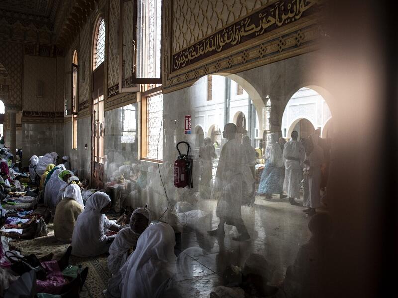 Worshippers enter the Great Mosque of the Mourides on September 27, 2019 in Dakar, ahead of its inauguration. Senegal's influential Mouride Brotherhood will inaugurate a 30,000-capacity mosque in the capital Dakar, said to be the largest in West Africa. JOHN WESSELS / AFP