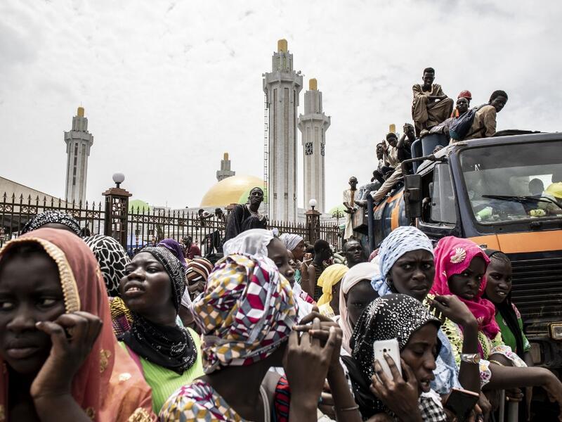 Worshippers are seen waiting outside the Great Mosque of the Mourides on September 27, 2019 in Dakar, ahead of its inauguration. Senegal's influential Mouride Brotherhood will inaugurate a 30,000-capacity mosque in the capital Dakar, said to be the largest in West Africa. JOHN WESSELS / AFP