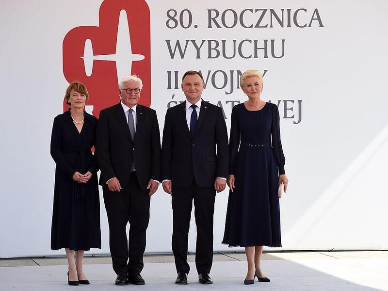 Polish President Andrzej Duda (centre right) with his wife Agata Kornhauser-Duda standing alongside German President Frank-Walter Steinmeier (centre left) and his wife Elke Buedenbender before commemorative ceremonies in Warsaw (AFP)