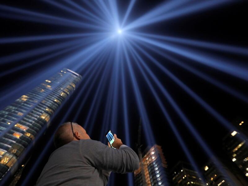 People look toward the Tribute in Light, lit up to commemorate the 18th anniversary of the September 11, 2001 attacks in New York, on Tuesday (Twitter)