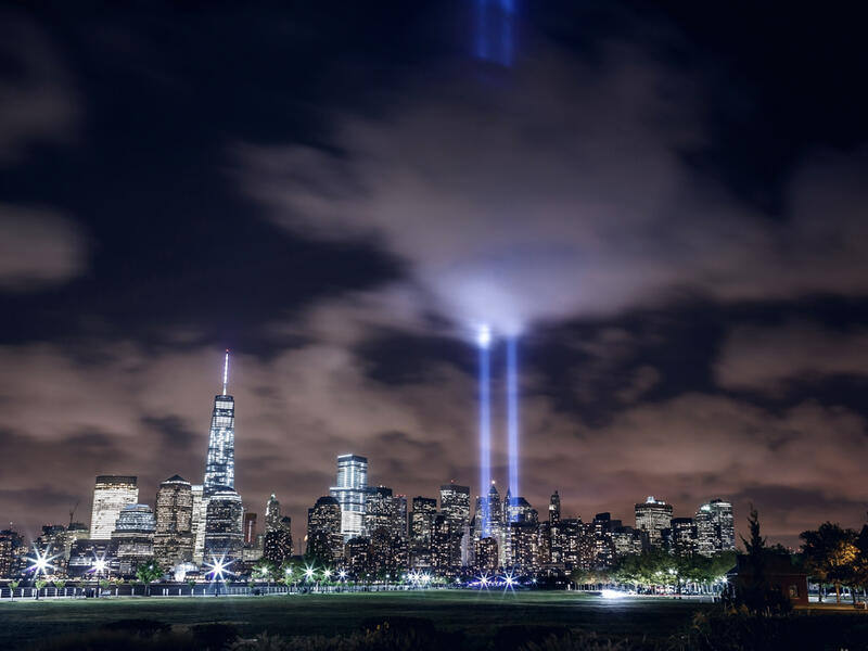 Illuminated Manhattan skyline with two beams of light in memory of 9/11 (Shutterstock)	