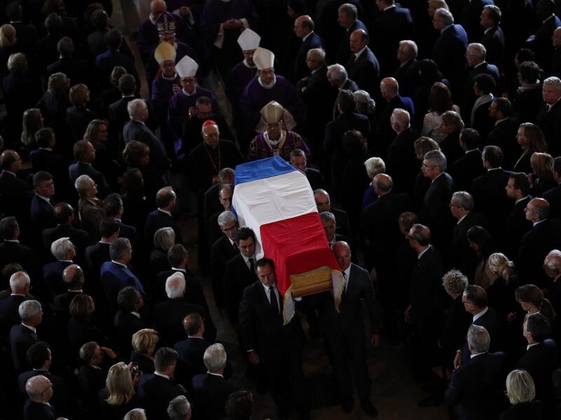 The coffin of the late French president Jacques Chirac is carried from the Saint Sulpice Church in the French capital Paris to a waiting hurst following his funeral service on September 30, 2019.  Francois Mori / POOL / AFP