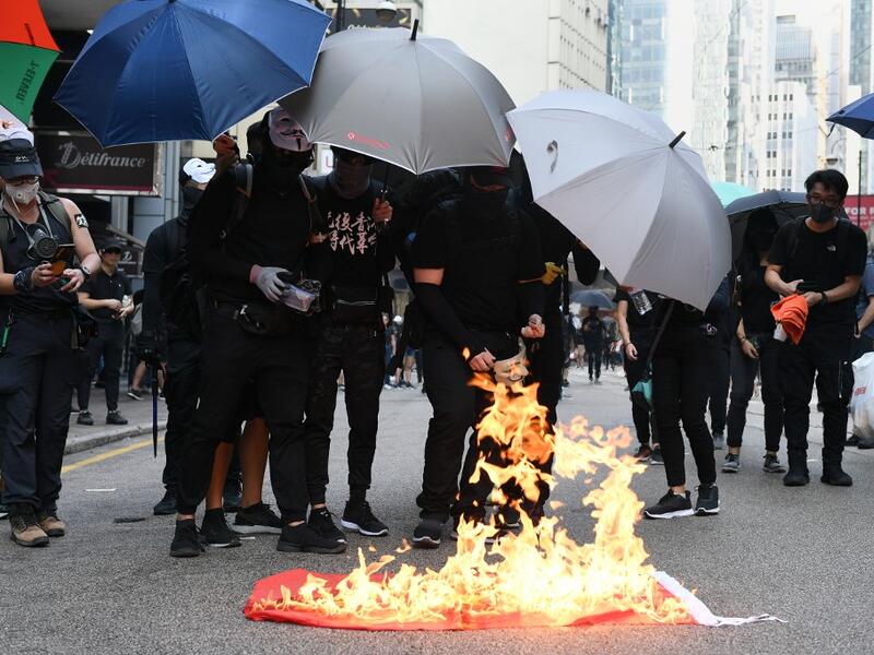 Protesters burn a Chinese national flag during a march through the streets of Hong Kong on October 1, 2019, as the city observes the National Day holiday to mark the 70th anniversary of communist China's founding. (AFP/ File Photo)