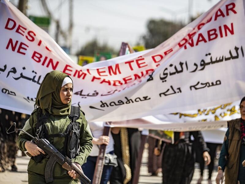 A member of the Kurdish Internal Security Police Force stands guard during a demonstration in front of the United Nations offices in the Kurdish-majority city of Qamishli in northeast Syria on October 2, 2019 over the Kurds exclusion from the UN-backed constitutional committee. Delil SOULEIMAN / AFP