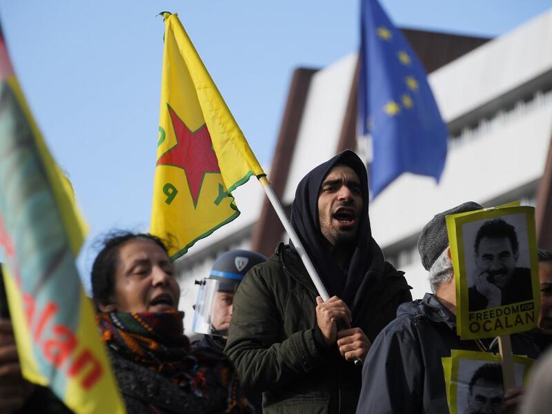 Kurdish demonstrators wave flags and hold portraits of Kurdish leader Abdullah Ocalan in front of the Council of Europe in Strasbourg, northeastern France, during a demonstration to protest against Turkey's military action in northern Syria on October 9, 2019. FREDERICK FLORIN / AFP