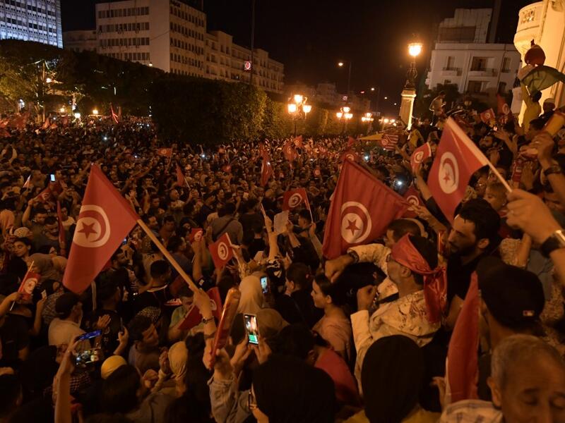 Tunisians gather to celebrate the victory of Kais Saied in the Tunisia's presidential runoff on October 13, 2019, in the capital Tunis. Conservative academic Kais Saied, a political outsider, won a landslide victory Sunday in Tunisia's presidential runoff, sweeping aside his rival, media magnate Nabil Karoui, state television said. Fethi Belaid / AFP
