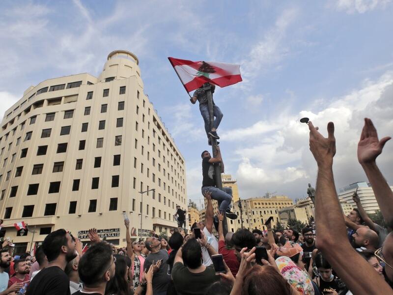 Lebanese demonstrators gather during a mass protest in the centre of the capital Beirut on October 18, 2019 against dire economic conditions. Public anger has simmered since parliament passed an austerity budget in July to help trim a ballooning deficit and flared on October 17 over new plans to tax calls on messaging applications such as WhatsApp, forcing the government to axe the unpopular proposal. ANWAR AMRO / AFP