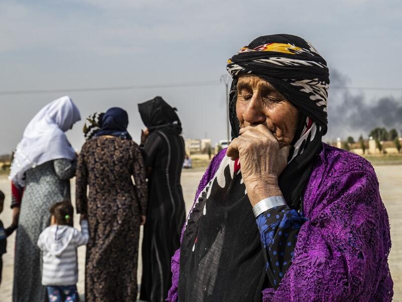 Mourners attend the funeral of civilians and fighters, who died during attacks by Turkish-led forces on the border town of Ras al-Ain, in a cemetary in Tal Tamr, near the Syrian Kurdish town of Ras al-Ain (AFP)