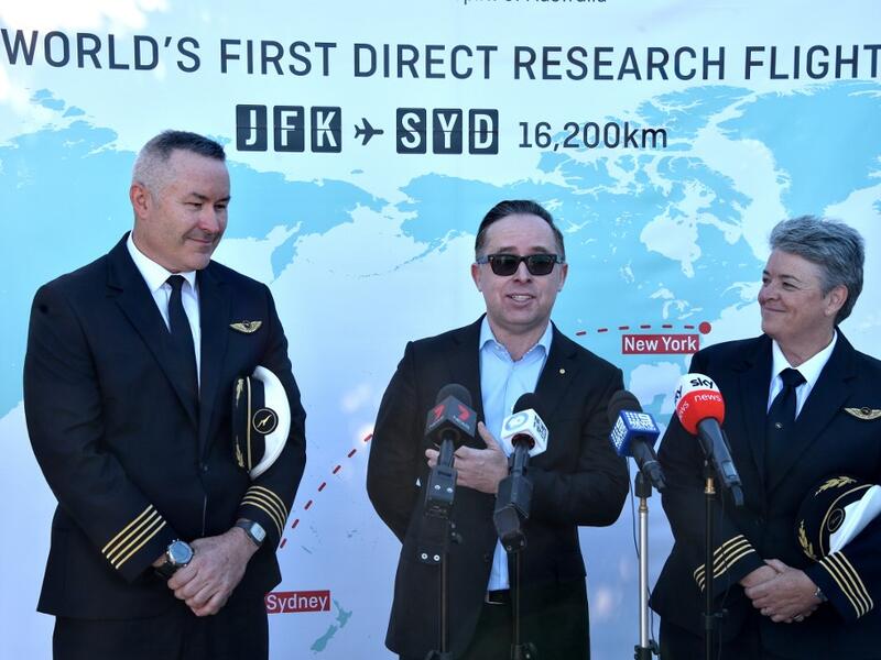Qantas Group CEO, Alan Joyce (C) Qantas pilot, Captain Sean Golding (L) and Qantas Fleet Manager, Lisa Norman (R) speak to the media after completing a non-stop test flight from New York to Sydney at Sydney international airport on October 20, 2019. The Qantas Boeing 757 completed the flight, non-stop New York to Sydney in 19 hours and 15 minutes. (PETER PARKS / AFP)