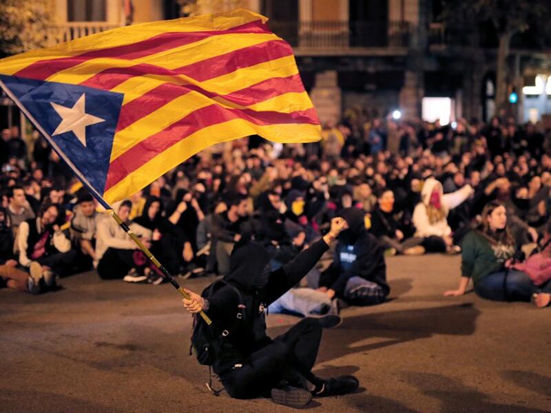 A protester waves a Catalan pro-independence "Estelada" flag during a protest outside the Spanish Government regional office in Barcelona on October 21, 2019. PAU BARRENA / AFP