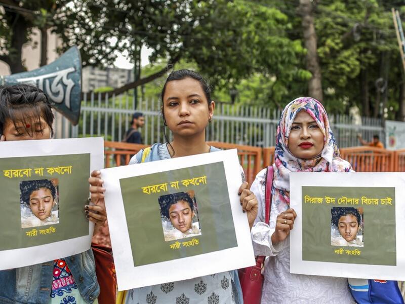 In this file photo taken on April 12, 2019 women hold placards with a photograph of schoolgirl Nusrat Jahan Rafi at a protest in Dhaka, following her murder by being set on fire after she had reported a sexual assault.  (AFP/ File Photo)