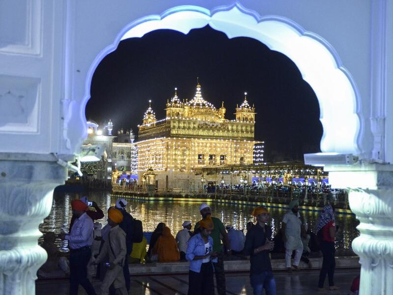 Indian Sikh devotees pay their respects on the eve of "Bandi Chhor Divas" or "Diwali" at the illuminated Golden Temple, in Amritsar on October 26, 2019. Sikhs celebrate 'Bandi Chhor Divas', also on the same day as the Hindu festival of Diwali, to mark the historic return of the sixth Guru, Guru Hargobind NARINDER NANU / AFP