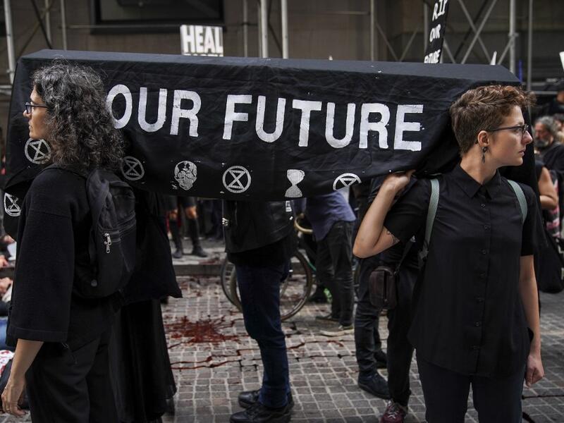 Environmental activists participate in a die-in during a rally for action against climate change in the Financial District October 7, 2019 in New York City. The group 'Extinction Rebellion' has organized protests and sit-ins around the globe today to push for action against climate change. Drew Angerer/Getty Images/AFP D