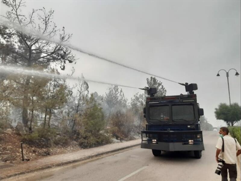 Riot control vehicles mounted with water cannons are employed to fight the fires in Chouf on Tuesday, Oct. 15, 2019. (The Daily Star/Mohammed Zaatari)