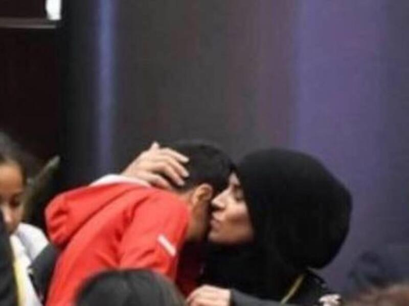 Woman at the general assembly comforting her son after having been asked to leave (Twitter)