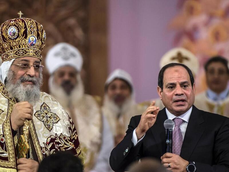 Egyptian president Abdel Fattah El Sisi speaks during a Christmas Eve mass as Coptic Pope Tawadros II looks on at the new Nativity of Christ Cathedral in Egypt's new administrative capital near Cairo on January 6, 2018. (Khaled Desouki / AFP) Egyptian president Abdel Fattah El Sisi speaks during a Christmas Eve mass as Coptic Pope Tawadros II looks on at the new Nativity of Christ Cathedral in Egypt's new administrative capital near Cairo on January 6, 2018. (Khaled Desouki / AFP)